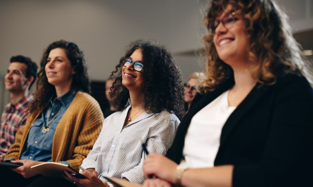 People in an audience at a conference